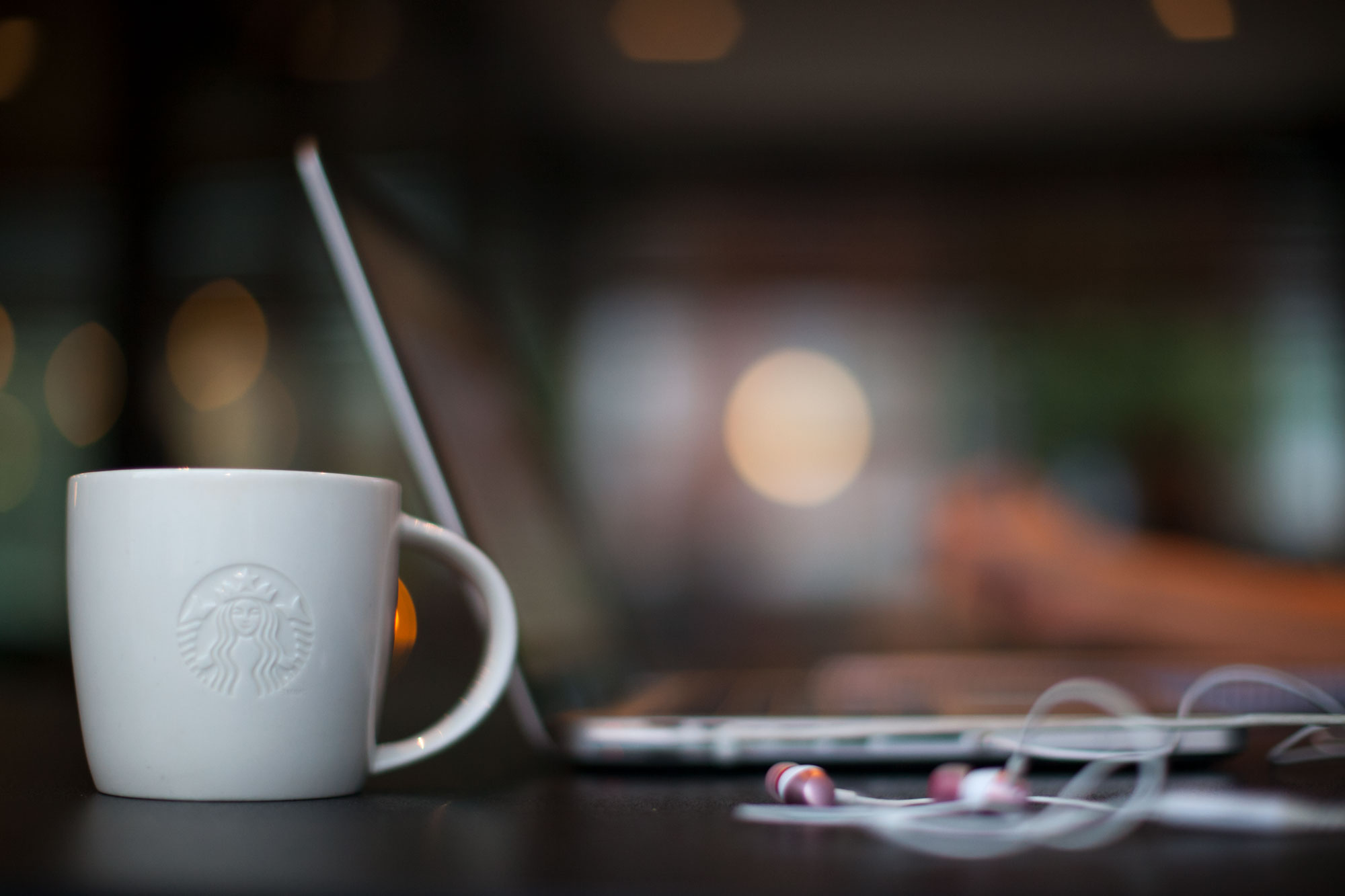 Starbucks Lifestyle Image with Mug, Laptop and Earbuds