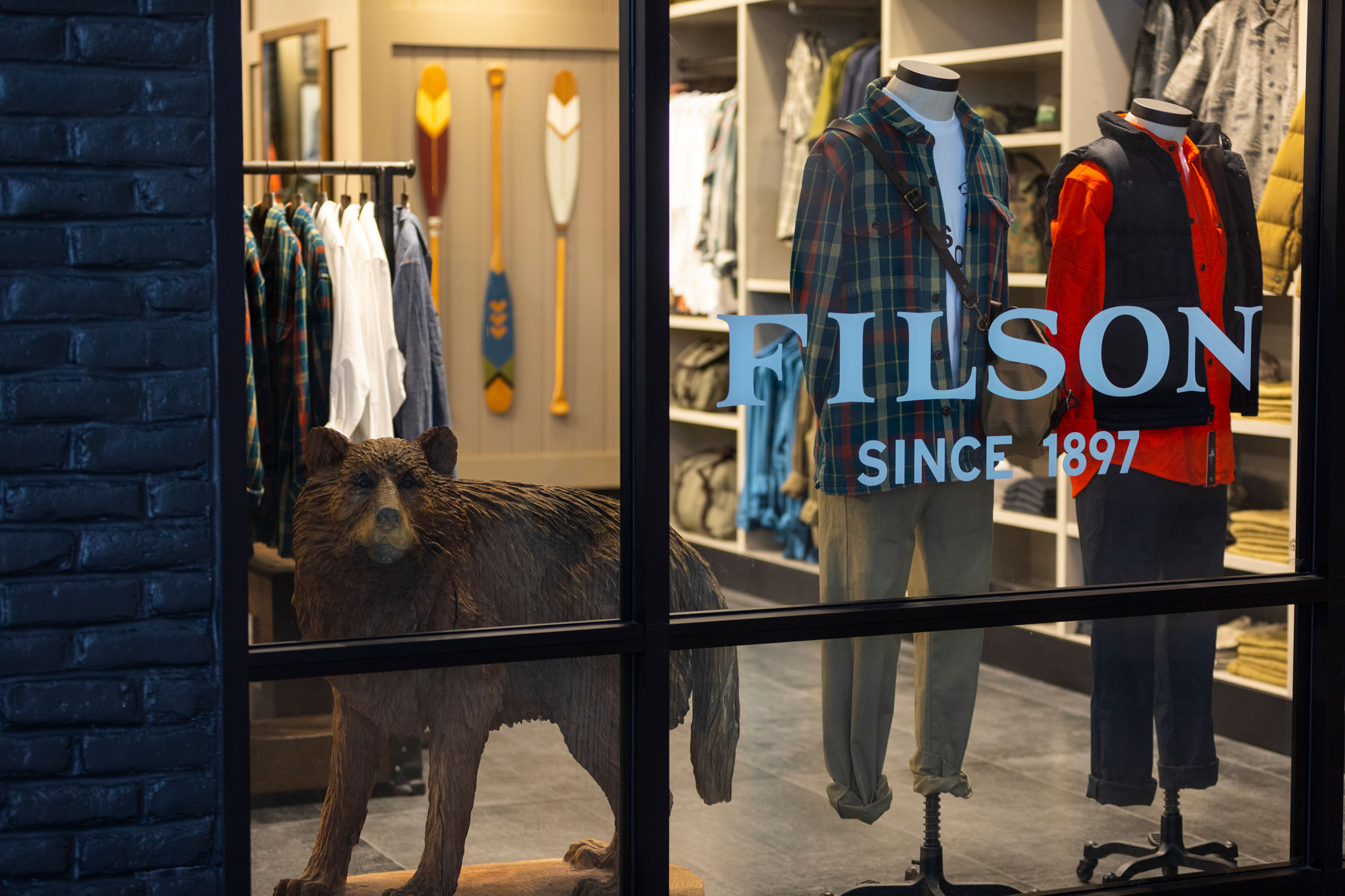Filson window shopping with mannequins and bear