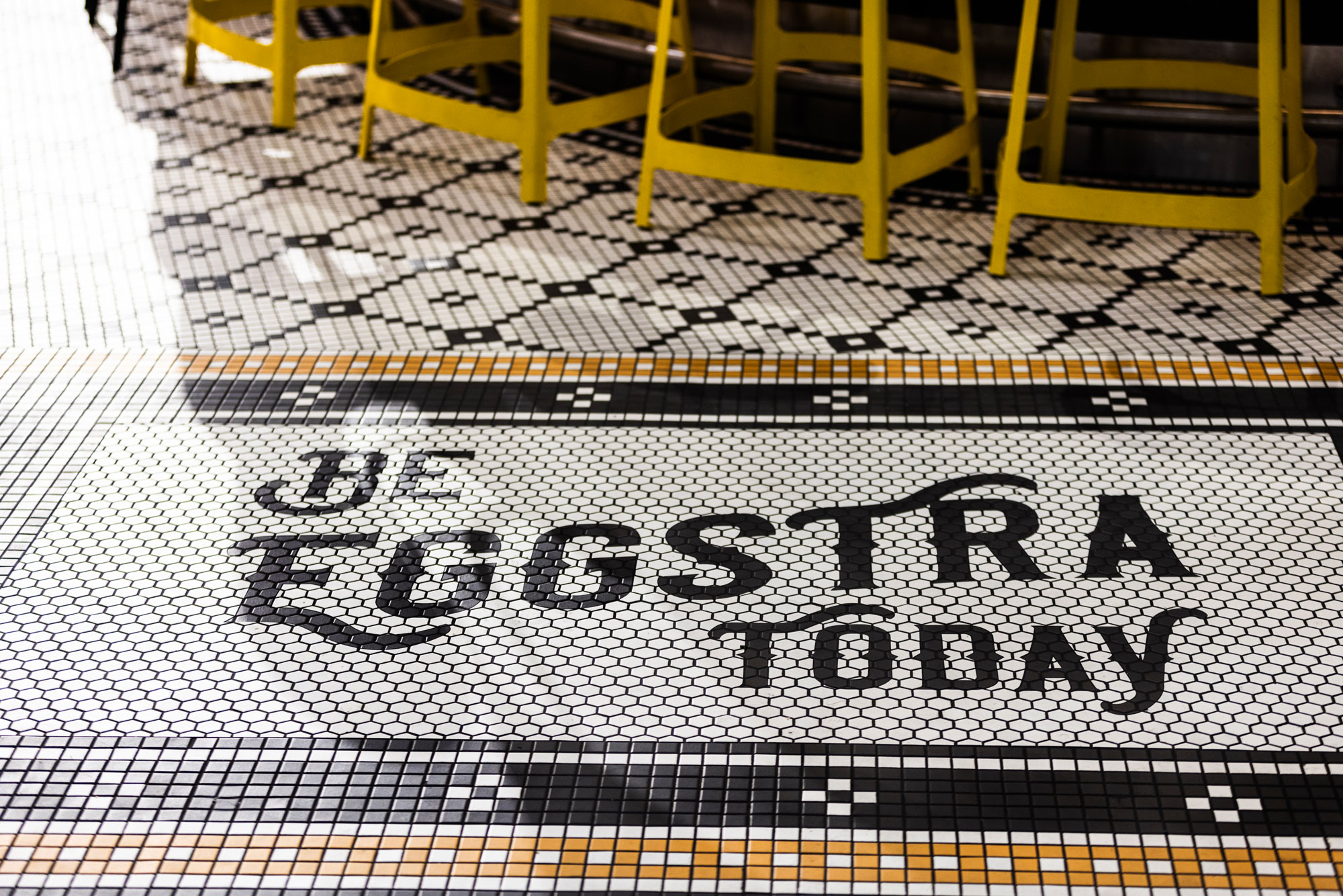 SEA Airport Bad Egg Breakfast Bar "Be Eggstra Today" floor design