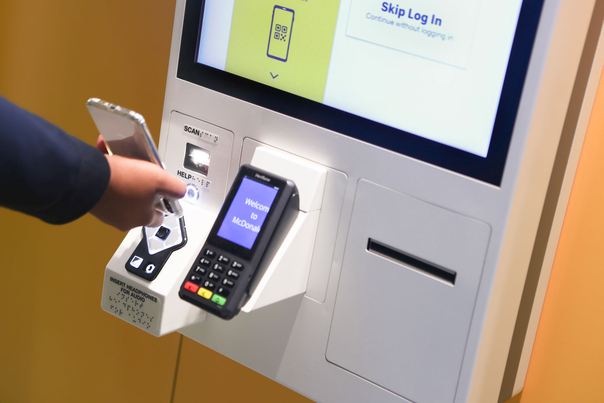 SEA McDonald's self-ordering kiosk close-up with customer paying