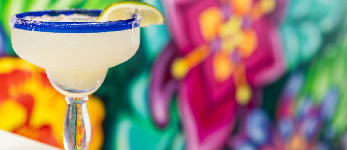 Mi Casa Cantina margarita with colorful background from restaurant decor