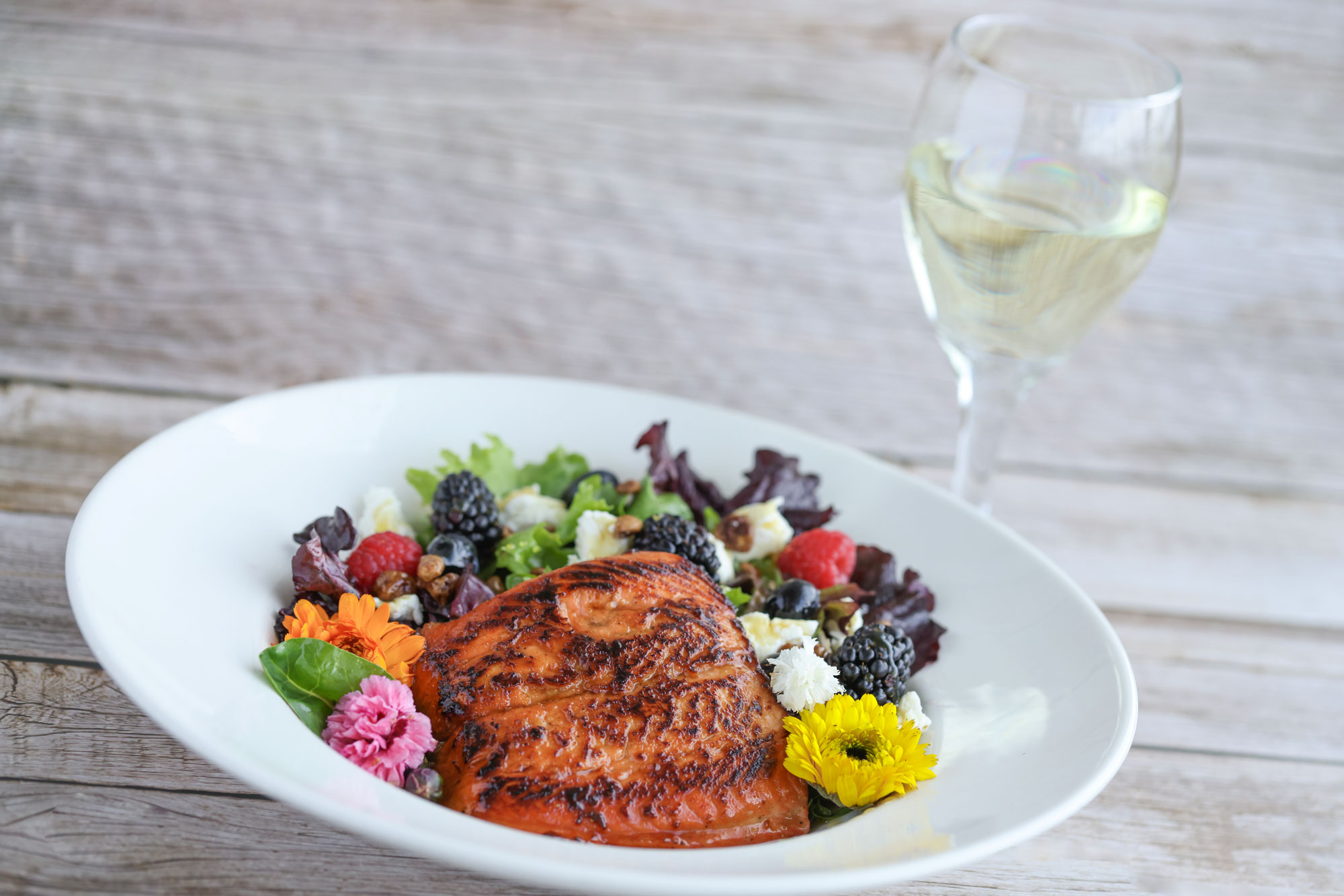 Salty's at the SEA salmon, salad, and white wine