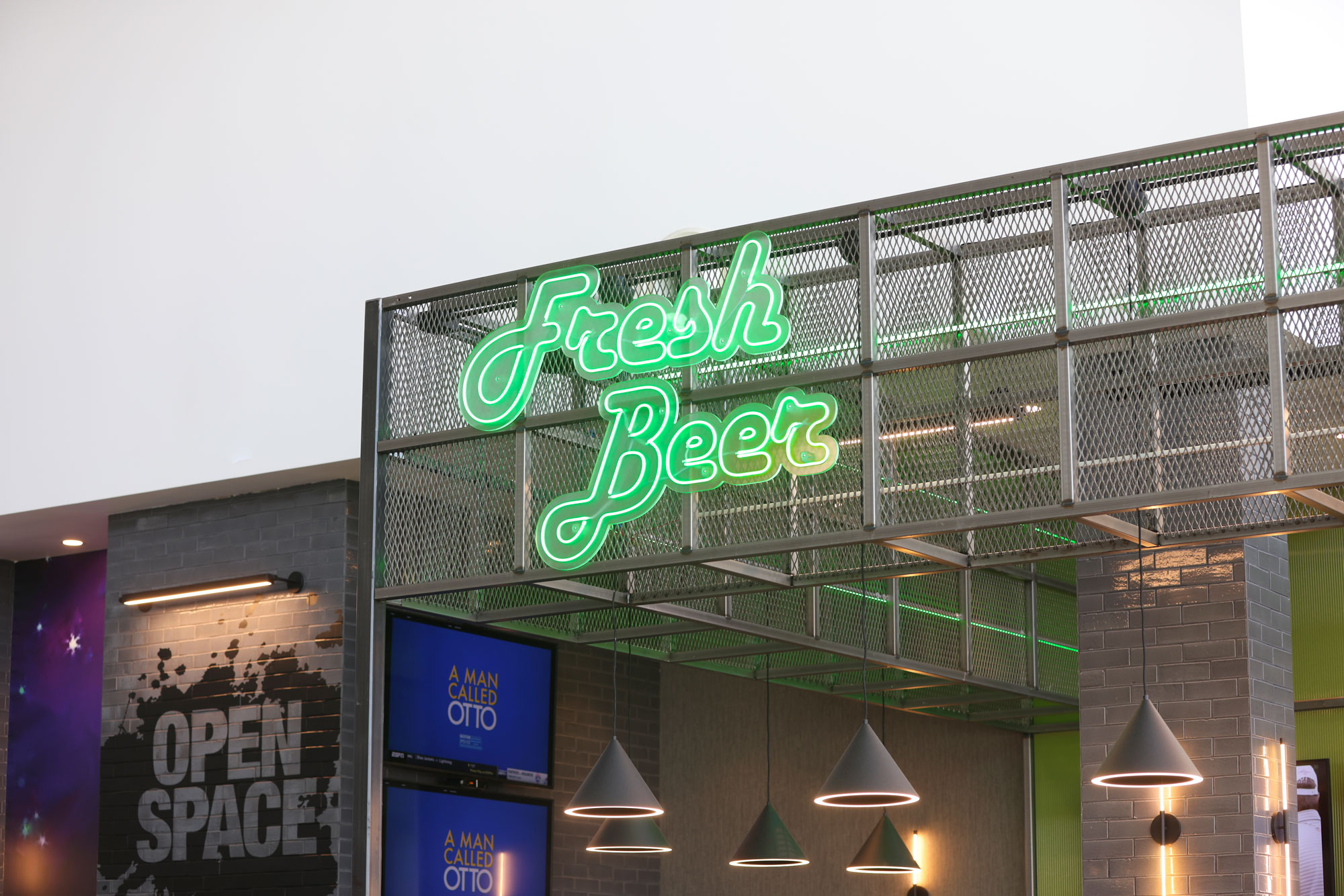 Open Space Tap Room Fresh Beer neon sign and decorative wall in the background
