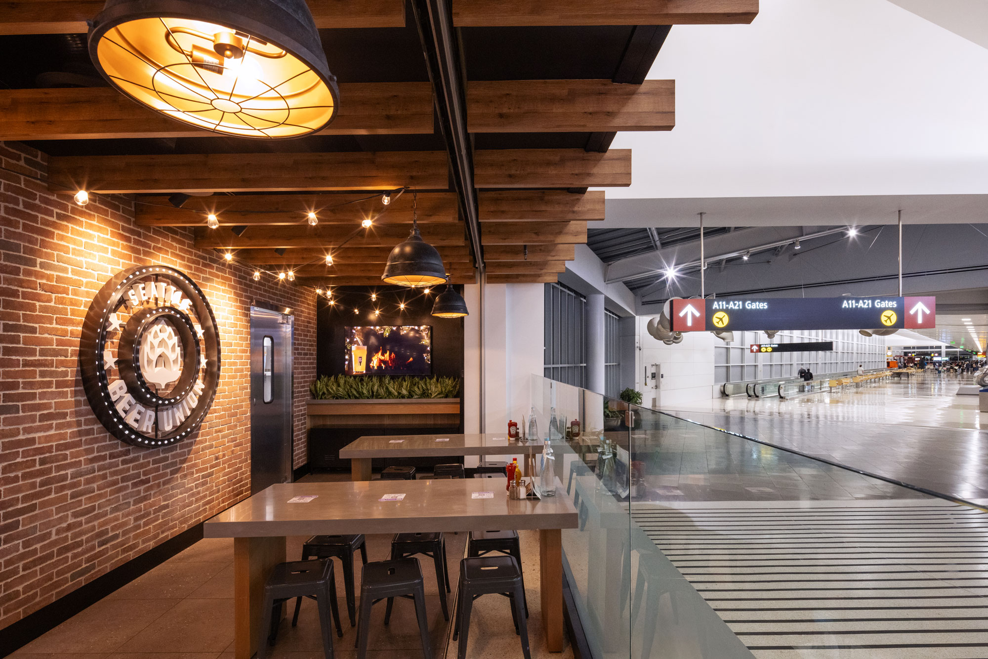 Seattle Beer Union seating with All Gates signage in the background