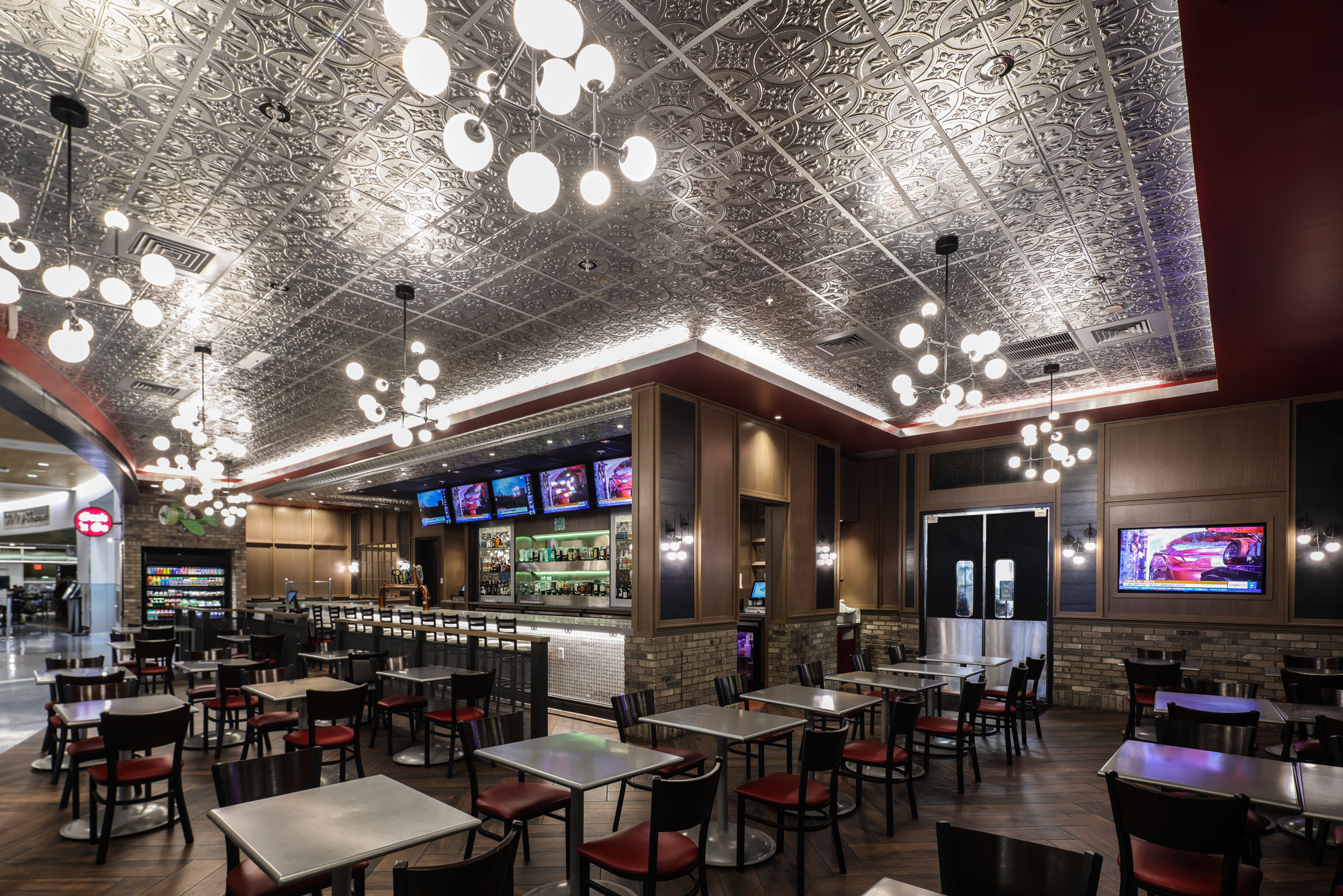 Village Pub interior with bar, seating area and decorative ceiling