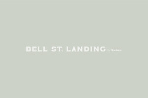 Bell St. Landing by Hudson inverted white logo on green/grey background