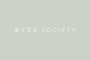 Bite Society inverted white logo on green/grey background