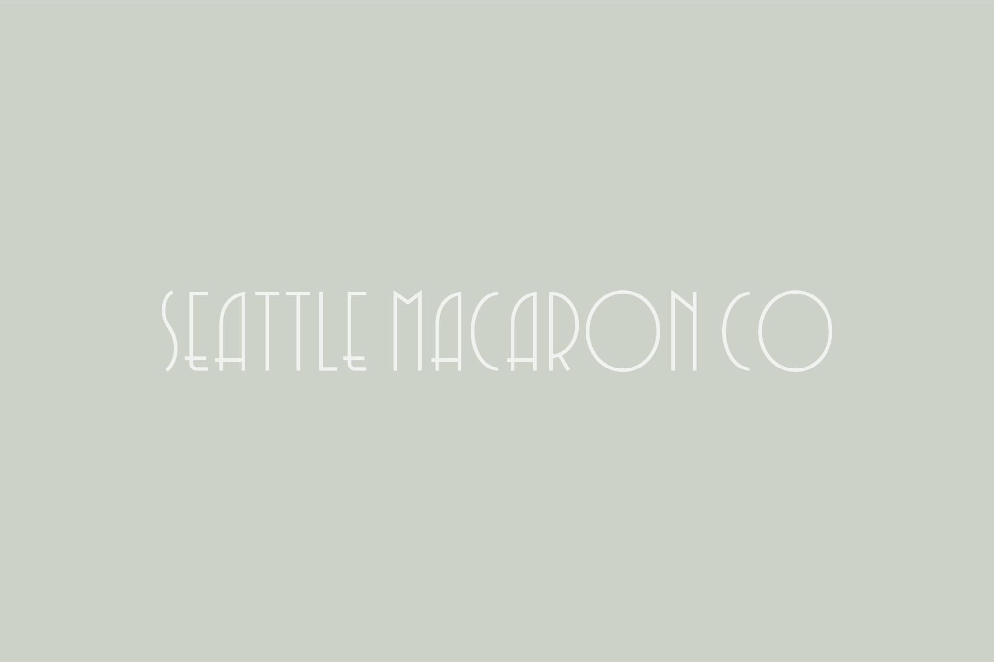 Seattle Macaron Co inverted white logo on green/grey background