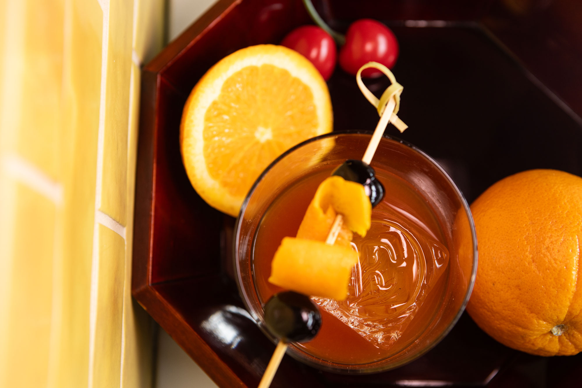 Embarque Whiskey Grill with colorful drink and oranges