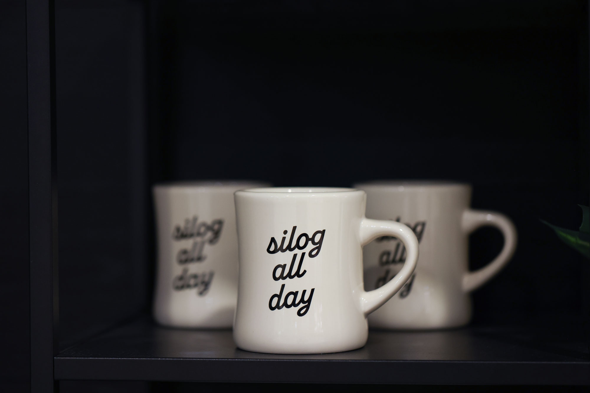Neighborhood Cafe merchandise showcasing mugs