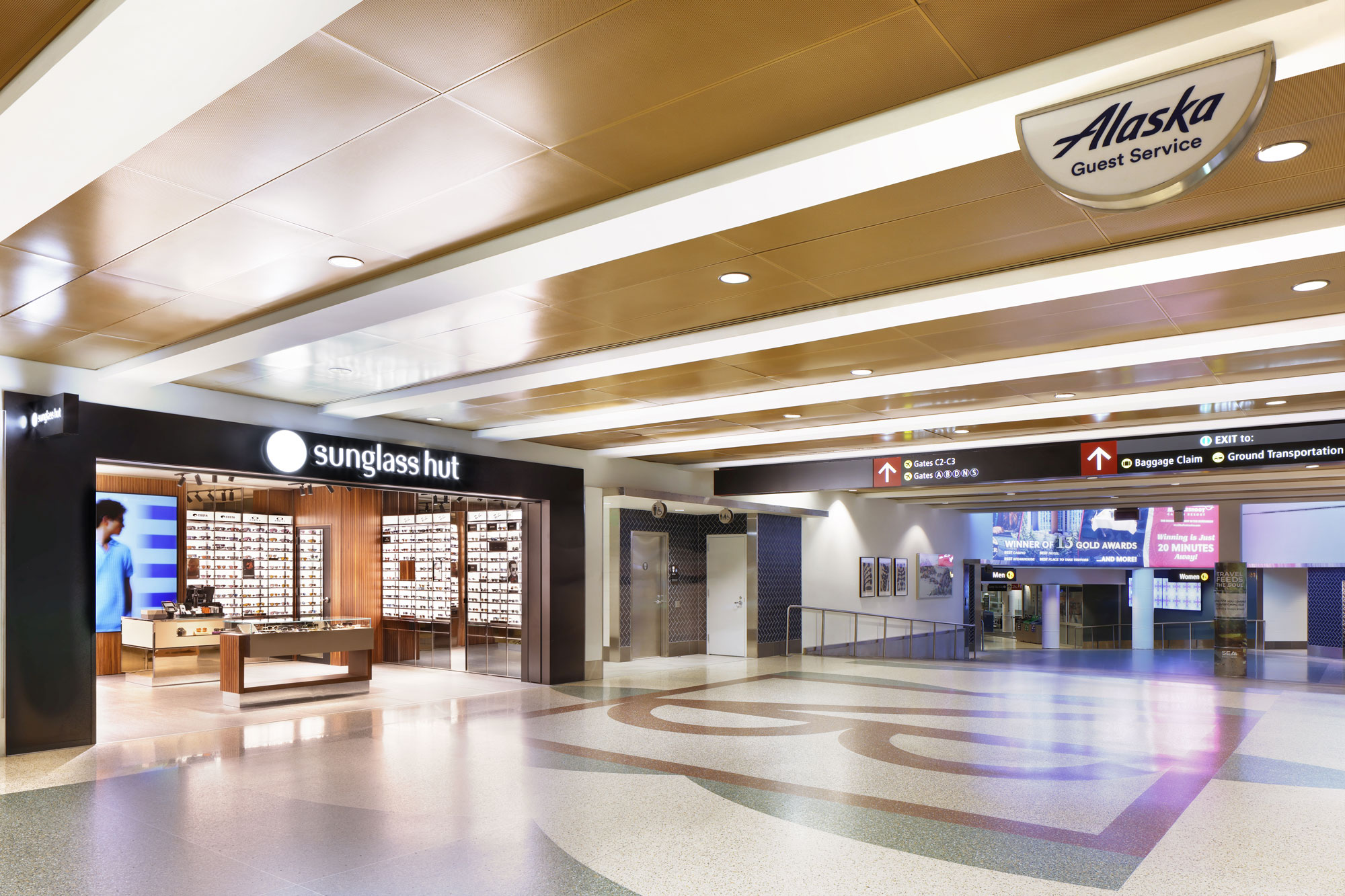 Sunglass Hut from terminal POV with Alaska Guest Service blade sign