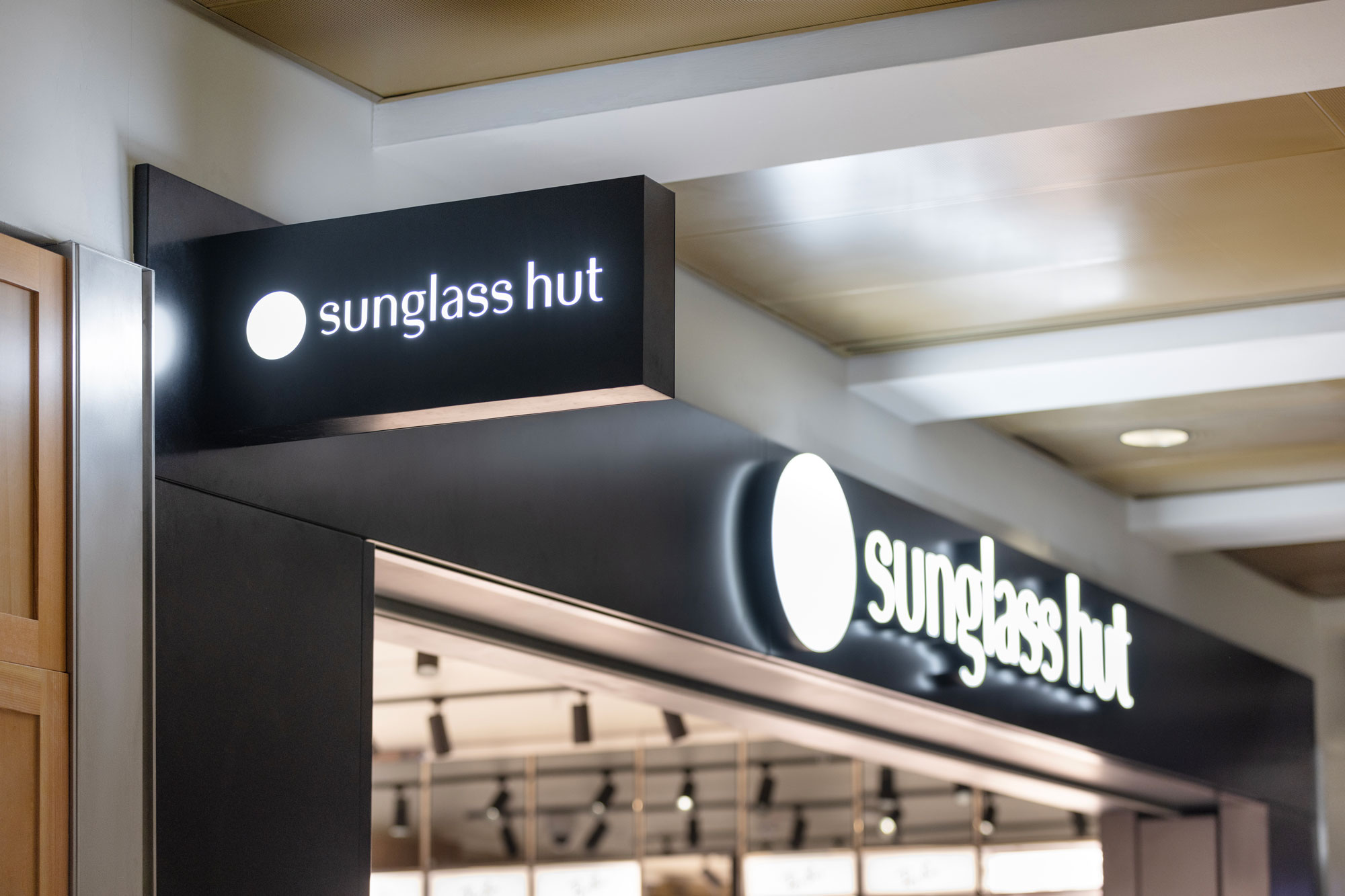 Sunglass Hut facade and blade sign