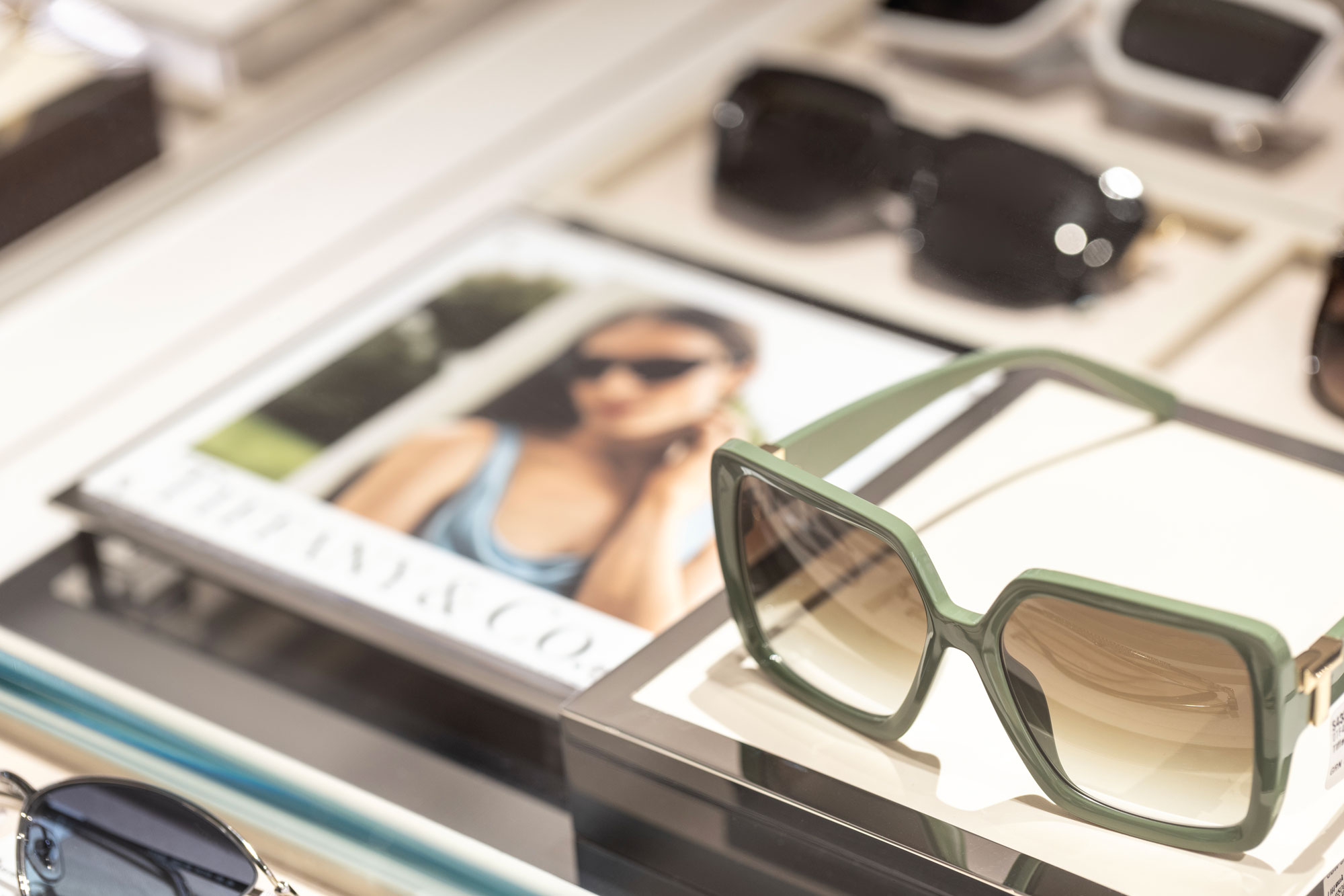 Sunglass Hut with closeup of green sunglasses