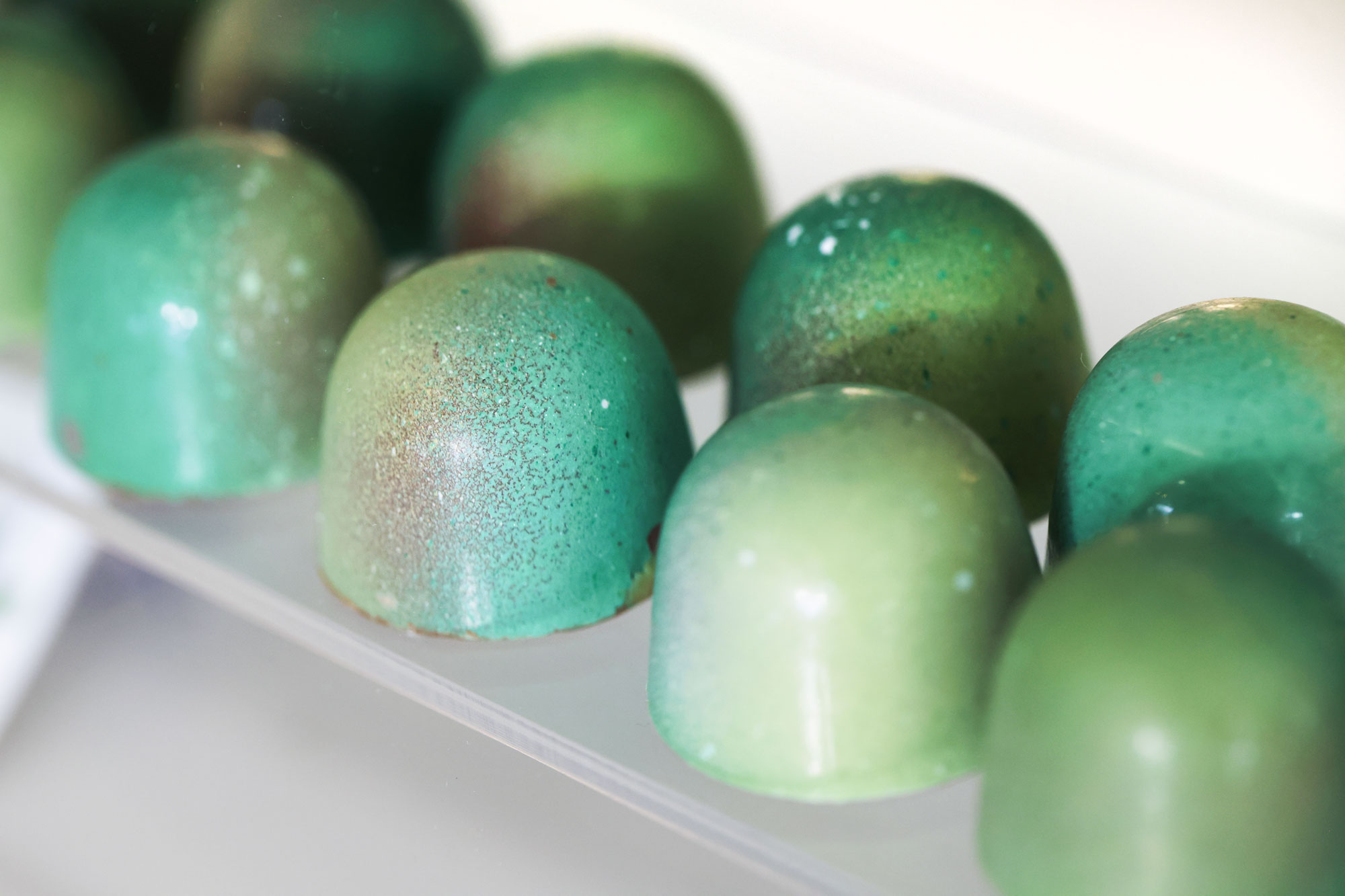 Theo Chocolate individual chocolate display with green chocolates