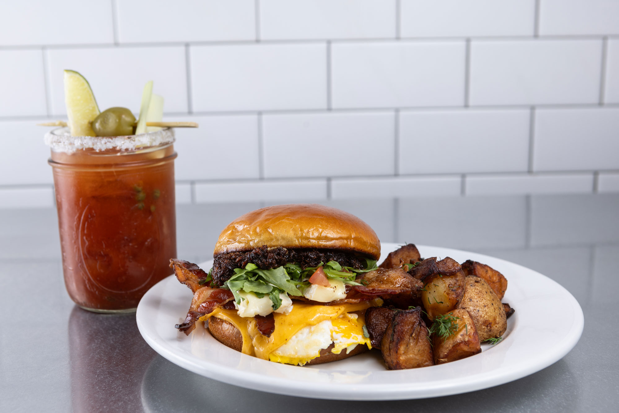 Skillet breakfast sandwich, potatoes and drink