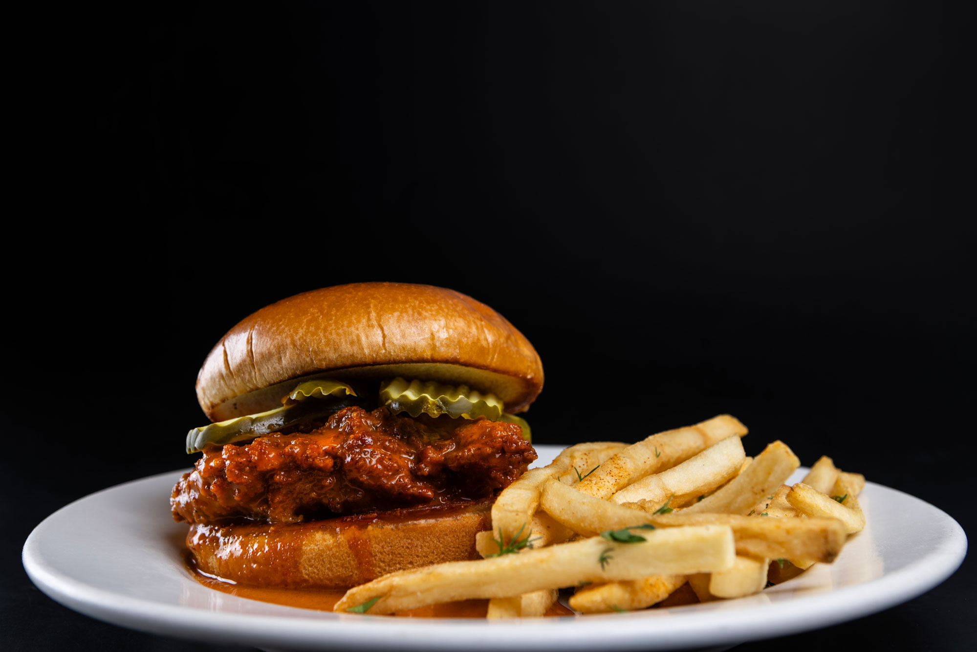 Skillet chicken sandwich with pickles and fries