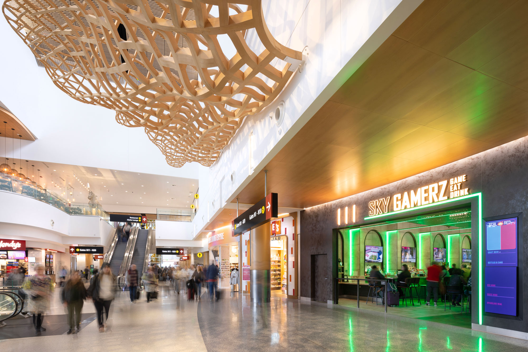 Sky Gamerz exterior with architectural artwork and escalators in the background