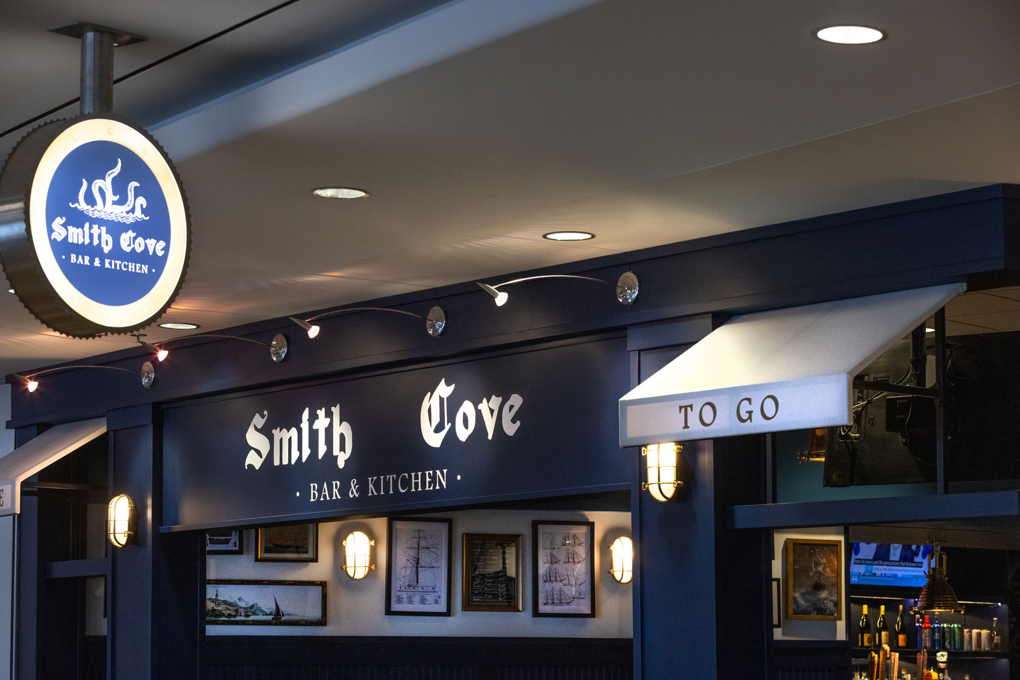 Smith Cove exterior with blade sign and To Go awning
