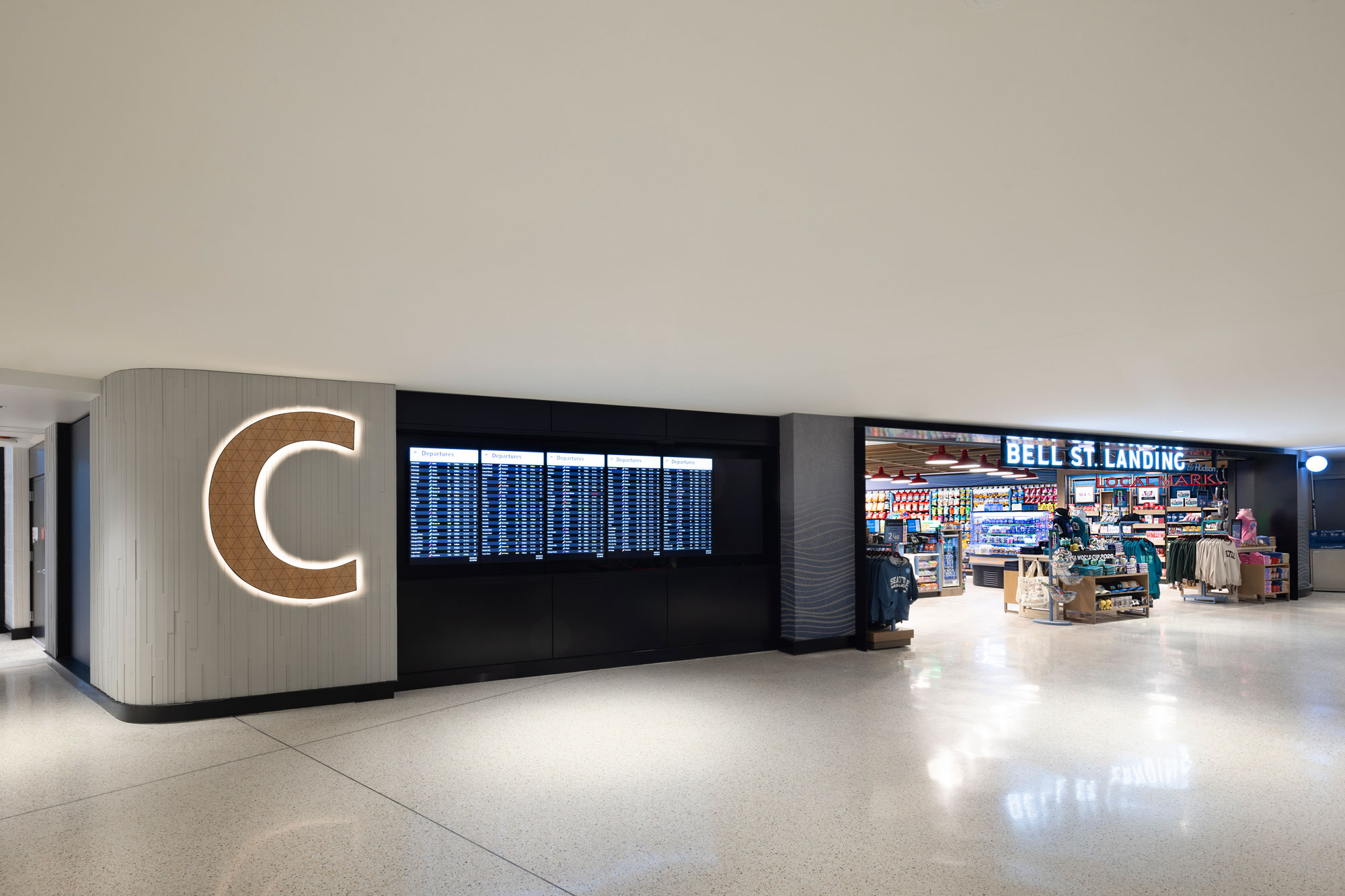 Bell St. Landing exterior with prominent C and flight information displays in the foreground