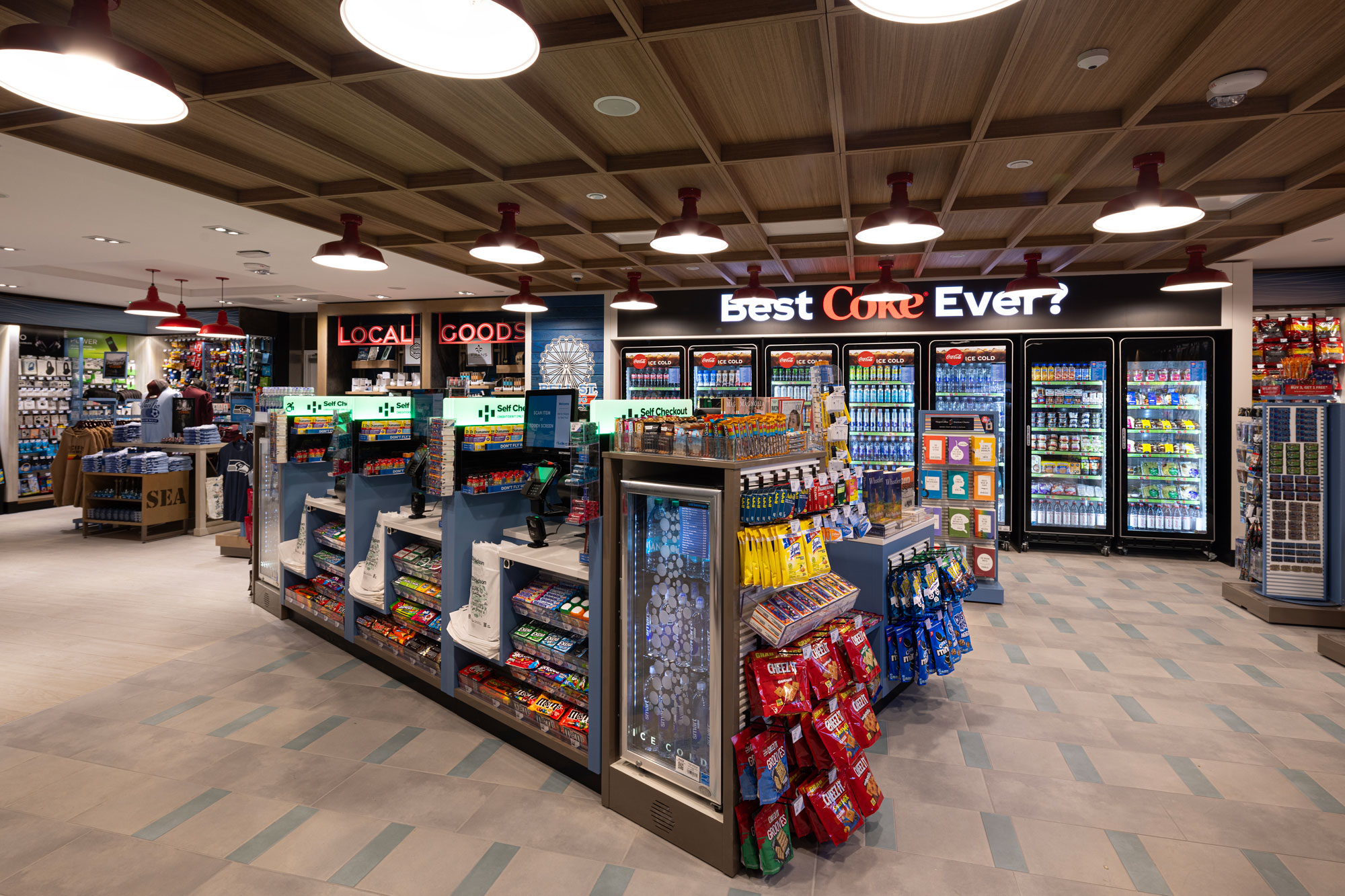 Bell St. Landing interior with beverage case and self-service check-out in the foreground