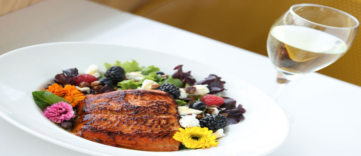 Salty's at the SEA plated food - salmon, salad, and champagne
